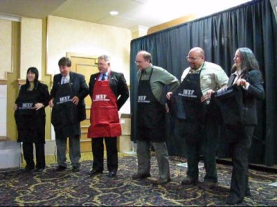 Merv Hoermann of the Iowa State Snowmobile Association passes out Beef aprons 